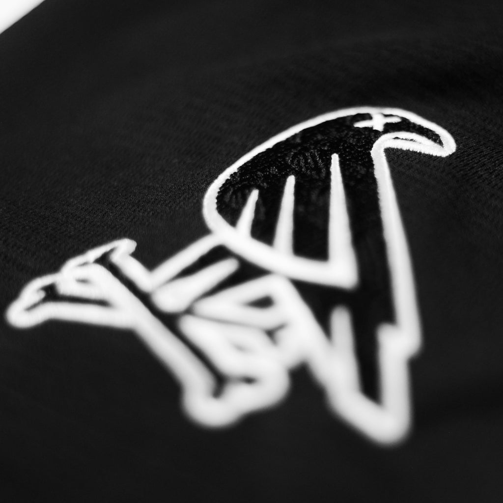 Classic B&W jersey by Crowdead. Sleeve Crow & Crossbones embroidery closeup