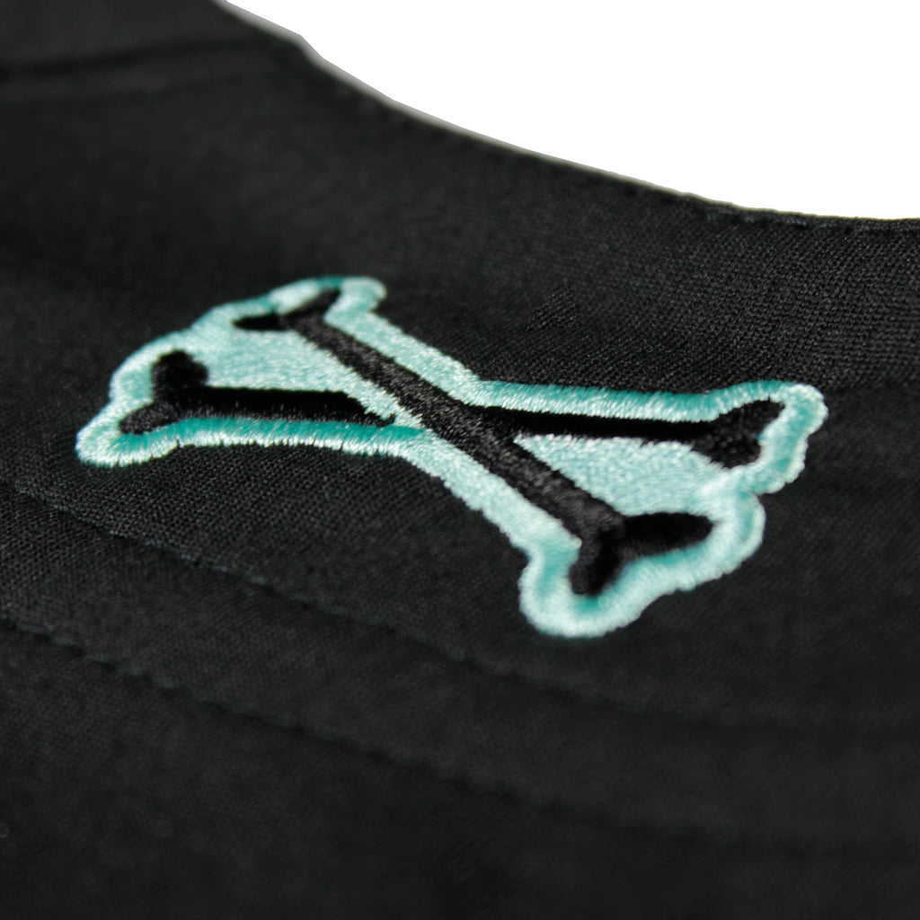 Black mint jersey by Crowdead. Closeup of embroidered crossbones on back.