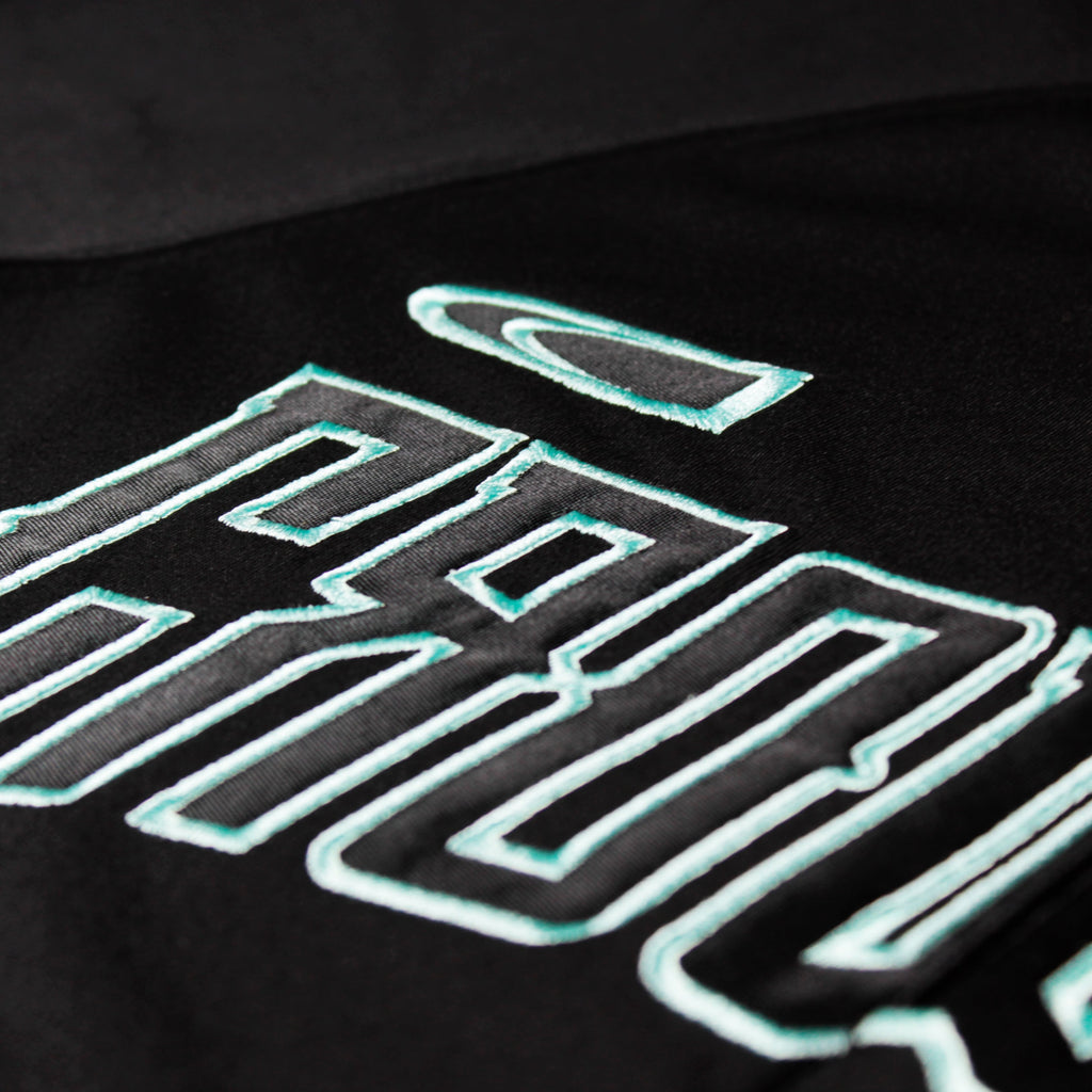 Black mint jersey by Crowdead. Front embroidery closeup.