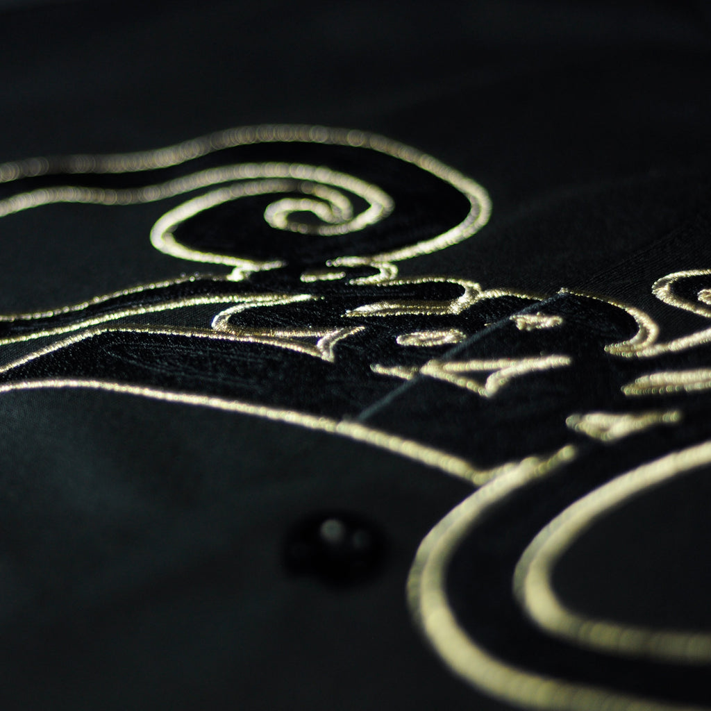 The new gold jersey by Crowdead. Front Crow signature embroidered logo closeup.