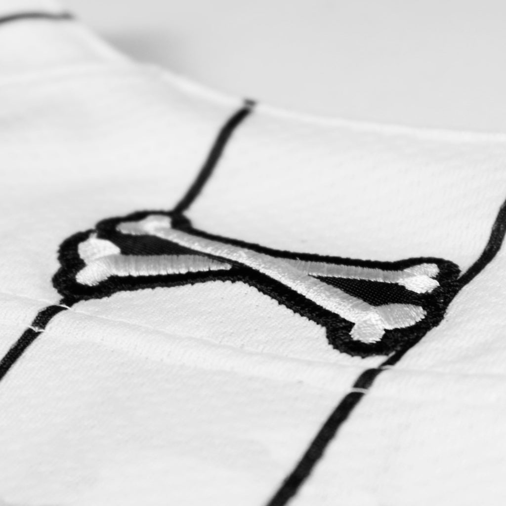 Referee volume 2 jersey by Crowdead. Rear Crossbones embroidered logo closeup.