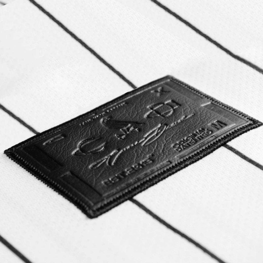 Referee volume 2 jersey by Crowdead. Side label engraved on black leather closeup.