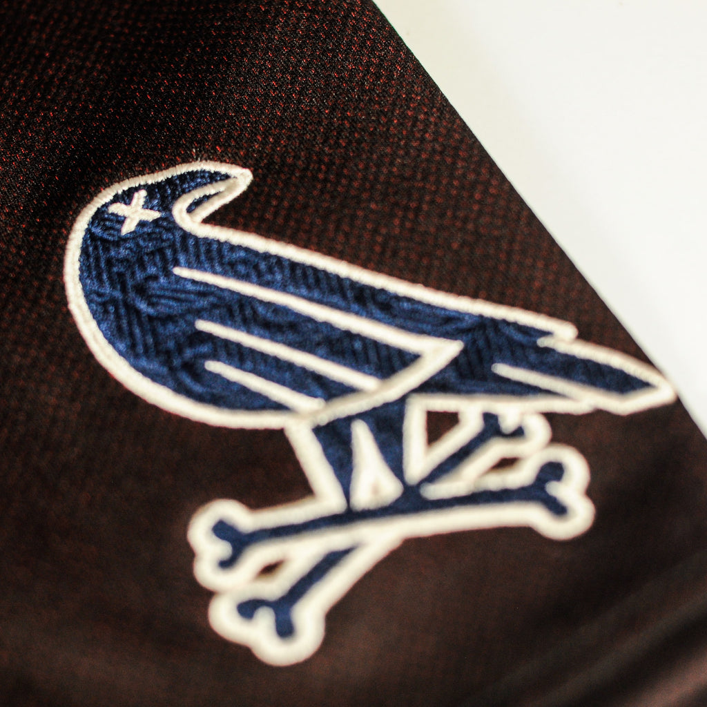 Closeup of sleeve logo on Tinto jersey by Crowdead streetwear.